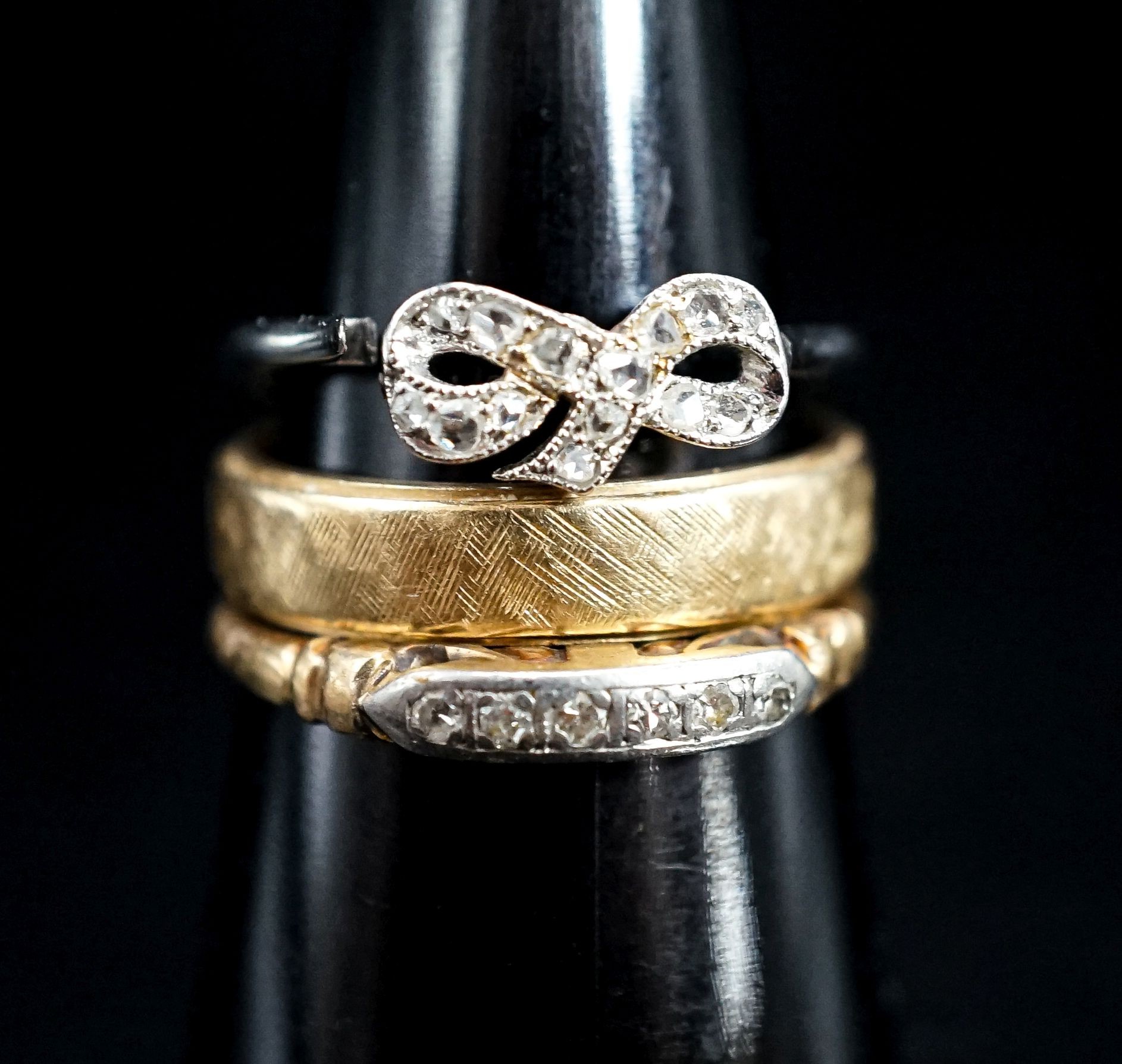 A 14k yellow metal band and two other diamond set rings, one stamped 14k, gross weight 7.5 grams.